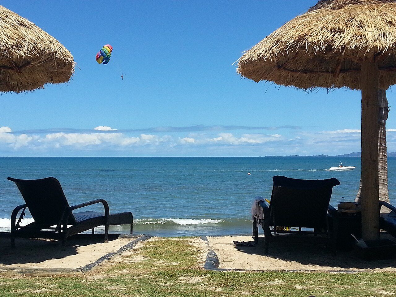 Sun chairs by the beach. Note that the sand and grass does not extend to the shoreline.