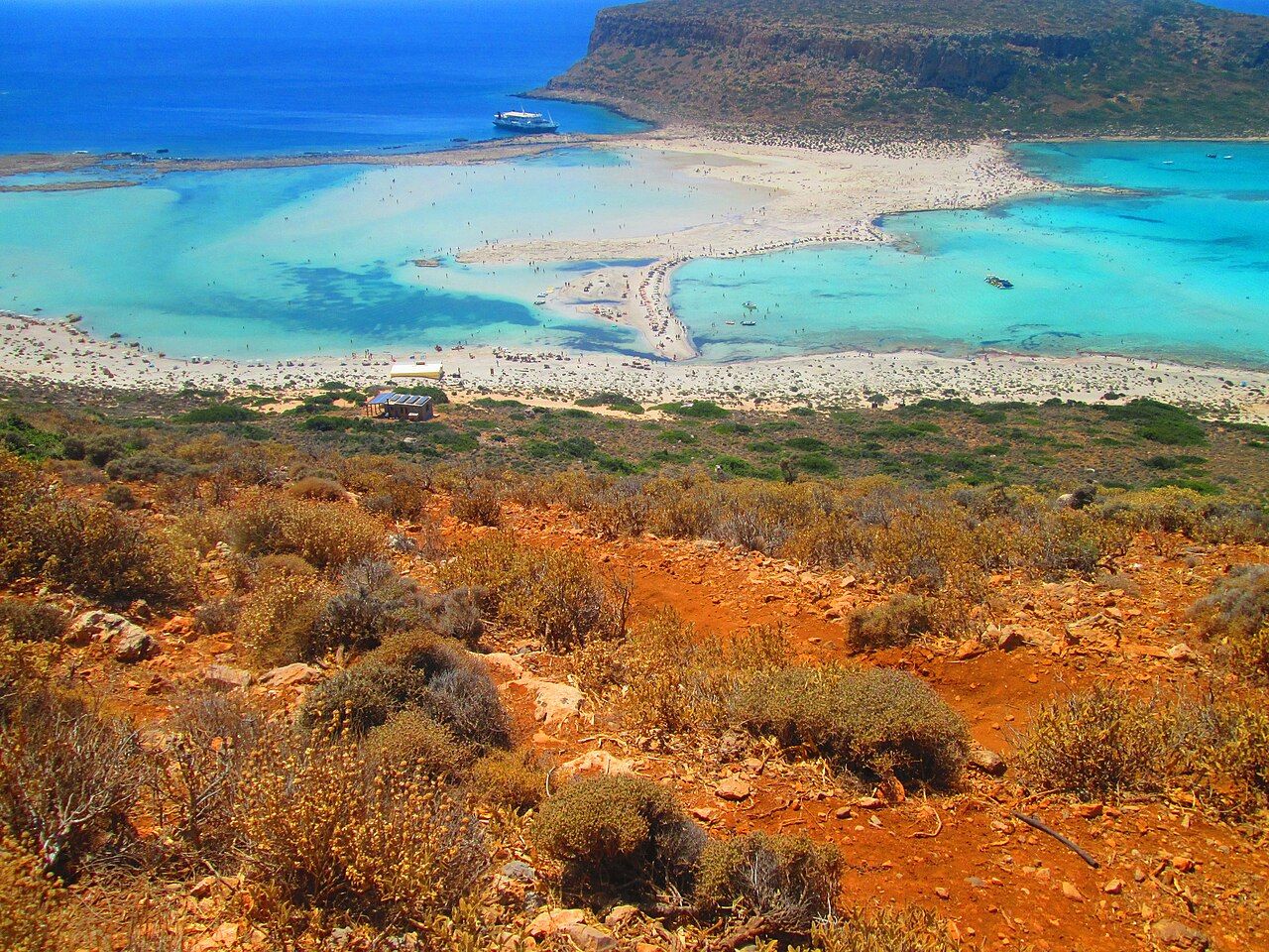 Balos Lagoon in Crete. The lagoon is visible on the left, separated from the sea by a small barrier island.