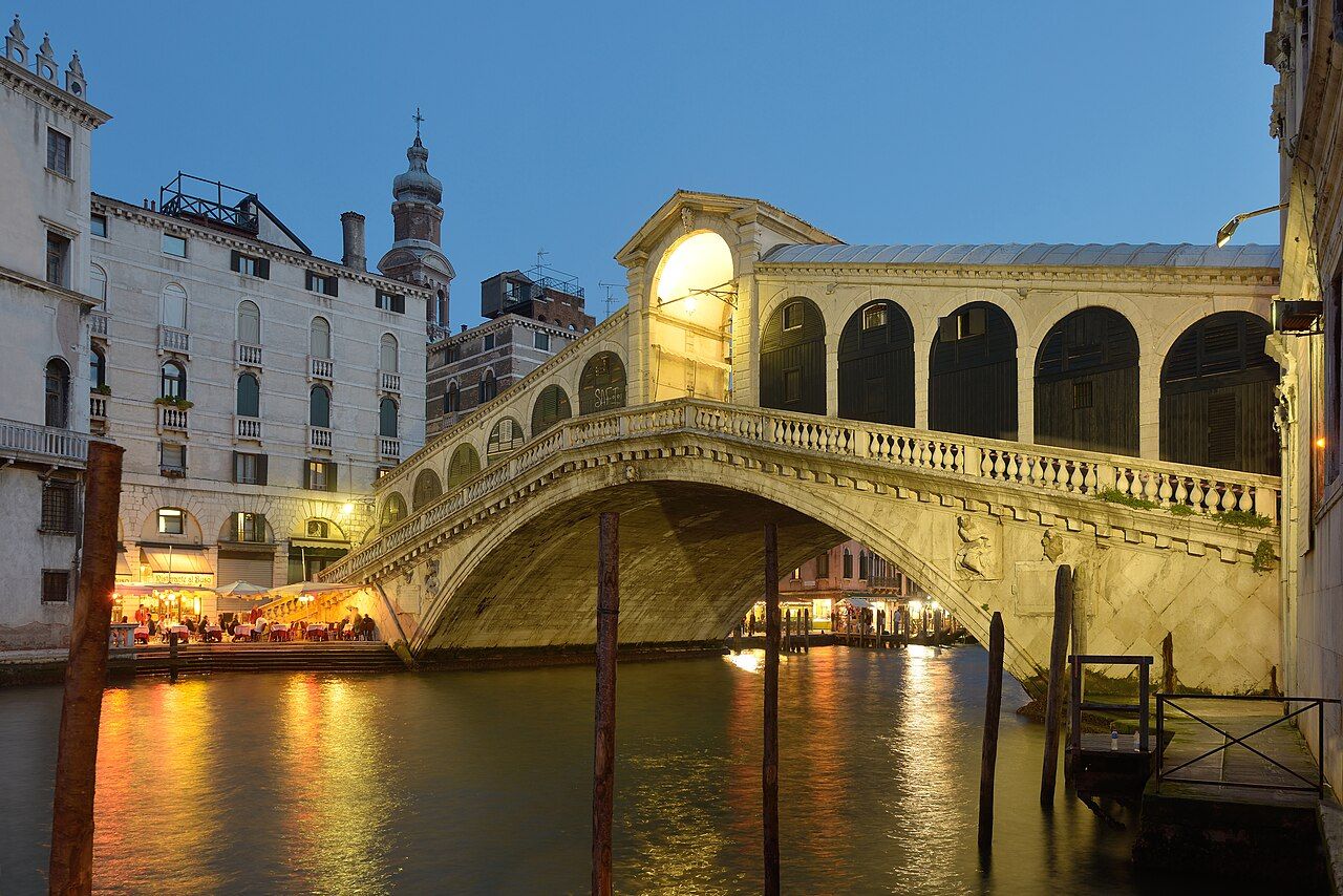The Rialto bridge at night in Venice.