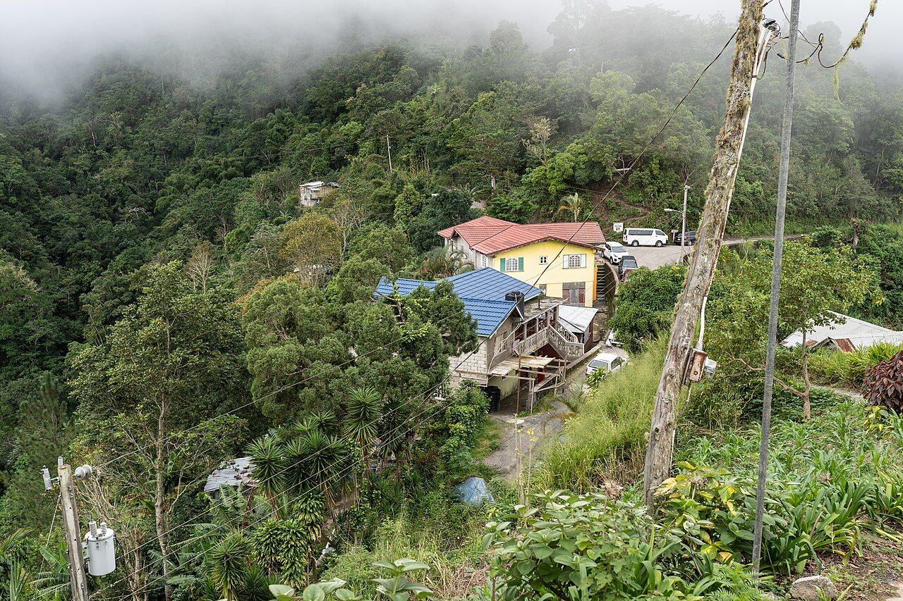 Fog hangs over the village of Section in the Blue Mountains of Portland Parish, Jamaica. The yellow building with the re