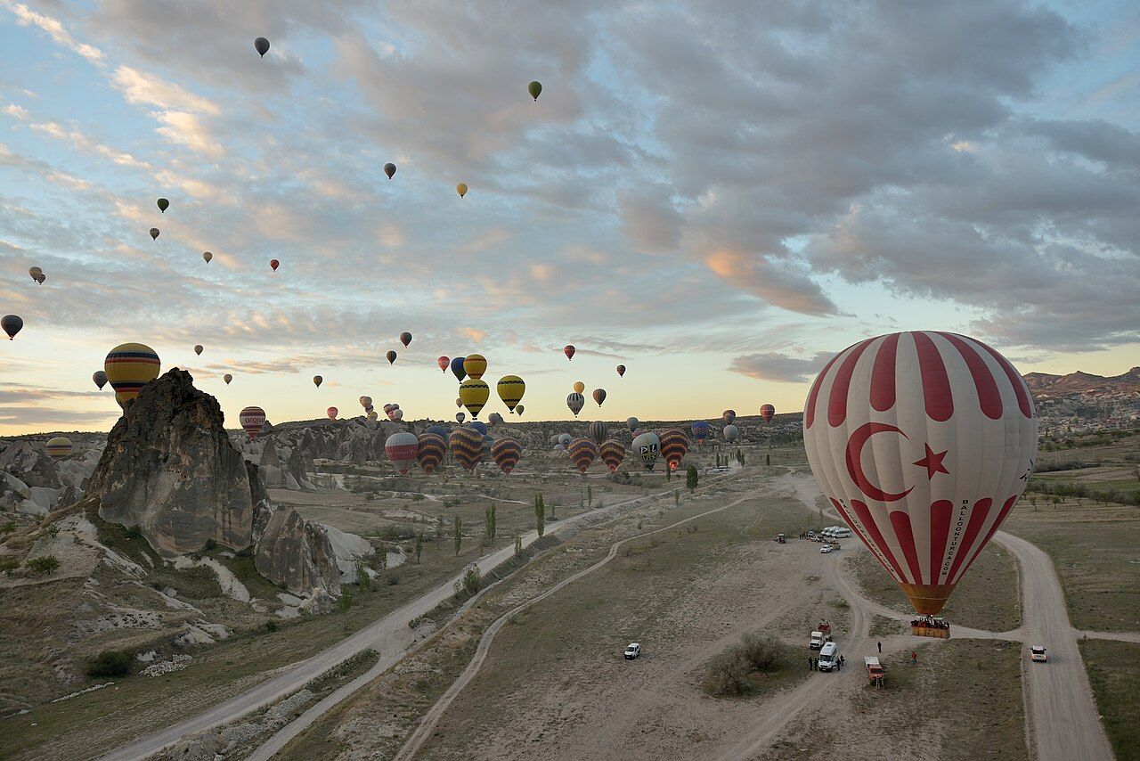Mass start of hot air balloon ride at dawn in Uçhisar in Cappadocia Turkey