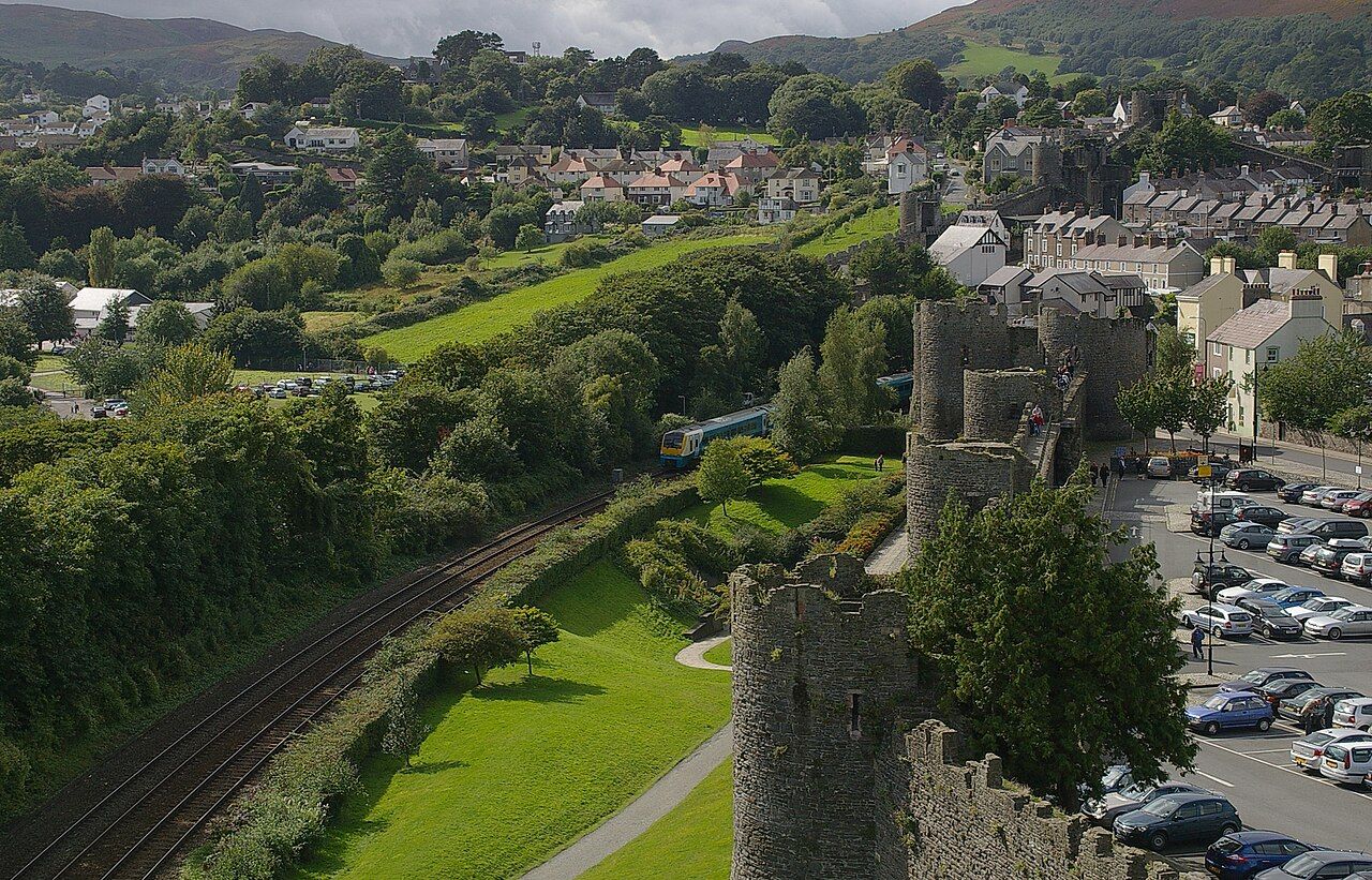 The North Wales Coast Line, viewed from Conwy Castle. Arriva Trains Wales 175116 is visible on its way to Holyhead.